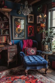 a blue chair sitting in front of a window with pictures on the wall behind it