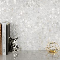 a bookend with a dog figurine next to it on a marble table