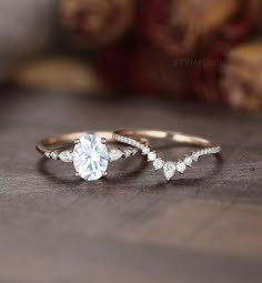 two gold rings with white diamonds on top