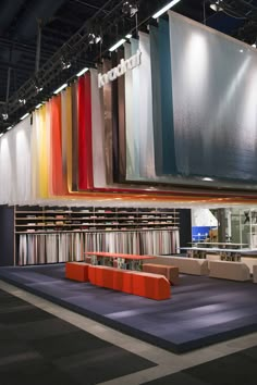 a large room filled with lots of different colored bookshelves next to each other