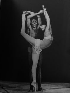 an old black and white photo of two dancers