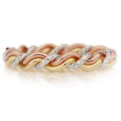 two tone gold and silver ring with twisted design on the inside, set against a white background