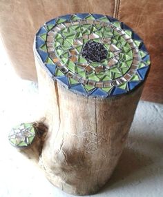 a piece of wood with a mosaic design on it's top and the bottom