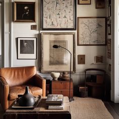 a living room filled with furniture and pictures on the wall