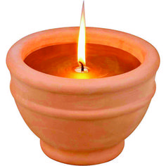 an orange candle is lit in a clay pot