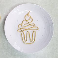 a white plate topped with a cupcake covered in icing