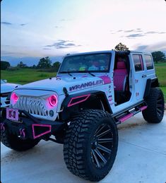 a white jeep with pink accents parked in a driveway