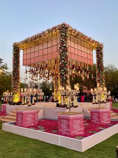 an outdoor stage decorated with flowers and candles