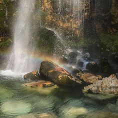 there is a rainbow in the water at this waterfall