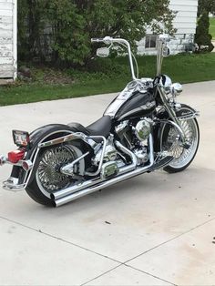 a black and silver motorcycle parked in front of a house