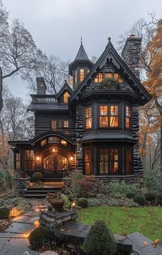 a large house with lots of windows and stone steps leading up to the front door