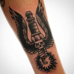 a black and white photo of a tattoo with a skeleton holding a wrench on it's arm