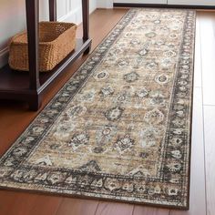 a large area rug on the floor in front of a table with a basket next to it