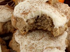 there are some cookies with white frosting on them and oranges in the background