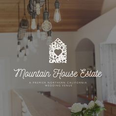 the mountain house estate logo is shown above a table with flowers and candles on it