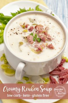 a bowl of creamy reuben soup on a white plate with green garnishes