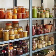 a shelf filled with lots of different types of food in jars next to a mirror