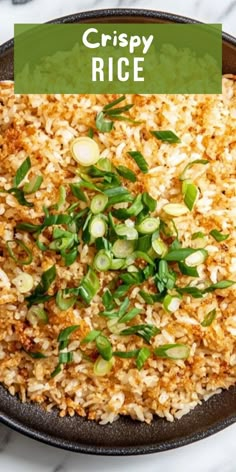 crispy rice in a skillet with green onions and scallions on top