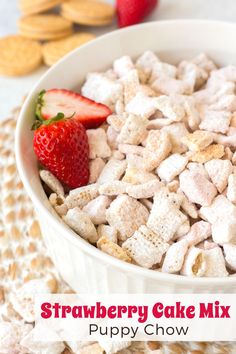 strawberry cake mix puppy chow in a white bowl with strawberries and crackers on the side