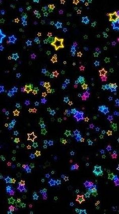 multicolored stars are scattered on a black background