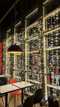 a room with tables and chairs covered in lights