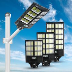 three solar powered street lights against a blue sky