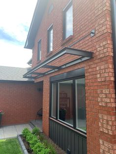 a red brick house with black trim and windows