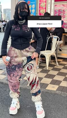 a woman in black jacket and pants standing on street