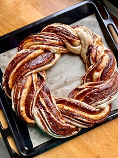 a round pastry sitting on top of a pan covered in cinnamon swirl doughnuts