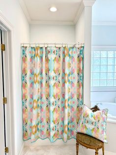 a bathroom with a chair and shower curtain