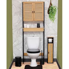 a bathroom with a toilet, cabinet and potted plant on the shelf next to it