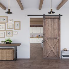 an open door leading to a kitchen with pictures on the wall