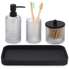 three pieces of bathroom accessories including toothbrushes, soap dispenser and tray