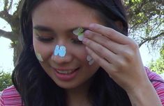 a girl with butterfly stickers on her face