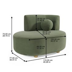 a green couch sitting on top of a white floor next to a tall ruler line