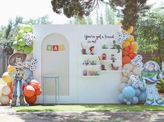 an outdoor birthday party with balloons and decorations