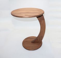 a wooden table with a circular base on it's side, against a white background