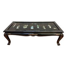 a coffee table with chess pieces on it and an ornate wooden frame around the top