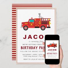 a birthday party with a firetruck and mobile phone on the table next to it