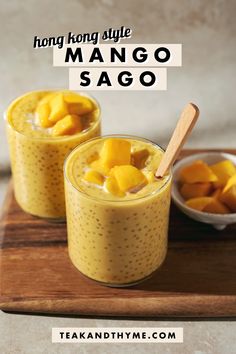 two glasses filled with mango sauce on top of a wooden cutting board