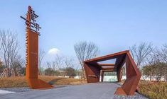 the entrance to an open air museum with large metal sculptures on it's sides