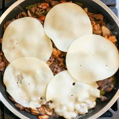 some food is cooking in a skillet on the stove top and ready to be eaten