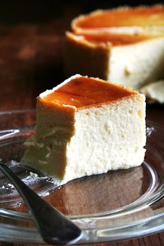 a piece of cheesecake sitting on top of a glass plate