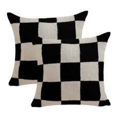 two black and white checkered pillows sitting next to each other