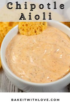 a white bowl filled with chipotle aioli next to some bread chips on the side