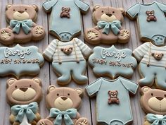 baby shower cookies with teddy bears and onesuits on wooden table next to each other