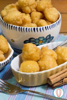 two bowls filled with fried food next to cinnamon sticks