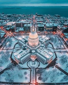 the capital building in washington d c is covered in snow as seen from above at night