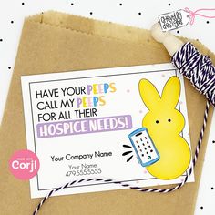 a brown envelope with a yellow bunny holding a cell phone and some twine on it