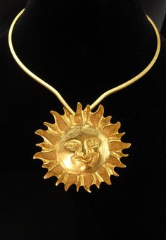 For the person who wants a little magic in their life, this large and fabulous large golden sun  pendant on this unusual shaped beautiful golden choker will bring in the compliments ! The gold plate is brilliant like Egyptian gold. See photos for more views and size.  3-4-21 Gold Seventies Inspired Jewelry, Collectible Celestial Sun And Moon Jewelry, Celestial Sun And Moon Collectible Jewelry, Elegant Sun And Moon Medallion Jewelry, Elegant Sun And Moon Design Medallion Jewelry, Celestial Gold Jewelry For Festivals, Gold Costume Jewelry For Festival, Celestial Sun Design Pendant Necklace, Adjustable Celestial Sun Design Jewelry